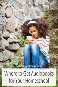 Girl looking at cell phone and listening - Where to Get Audiobooks for Your Homeschool
