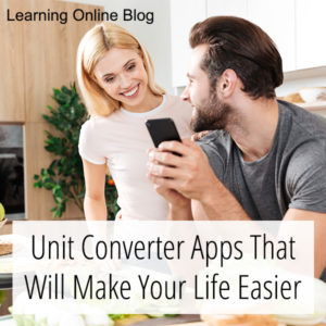Man and woman looking at cell phone in kitchen - Unit Converter Apps That Will Make Your Life Easier