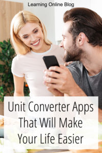 Man and woman looking at cell phone in kitchen - Unit Converter Apps That Will Make Your Life Easier