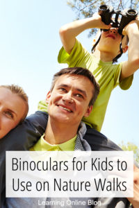 Child on dad's shoulders using binoculars - Binoculars for Kids to Use on Nature Walks