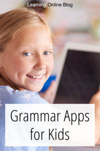 Smiling girl holding tablet - Grammar Apps for Kids