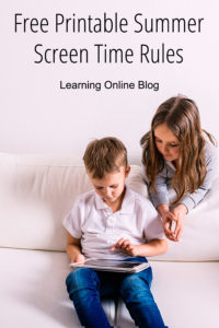 Two children looking at a tablet - Free Printable Summer Screen Time Rules