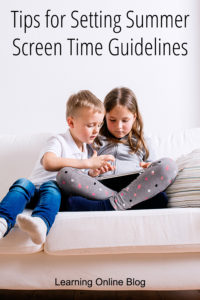 Two children looking at a tablet - Tips for Setting Summer Screen Time Guidelines