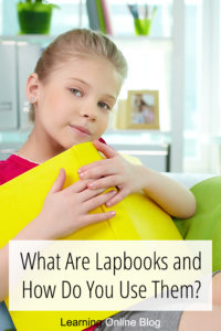 Girl holding book - What Are Lapbooks and How Do You Use Them?